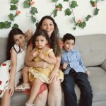 a group of people sitting on a couch posing for the camera