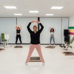 a group of people doing exercises in a room